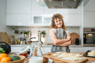 One happy young adult caucasian woman wear apron in the kitchen smile