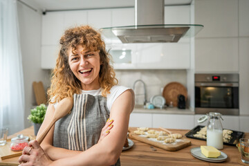 One happy young adult caucasian woman wear apron in the kitchen smile