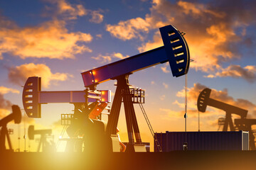 Oil field. Pumps pumping oil at sunset. Petroleum mining. Industrial landscape with hydrocarbon...