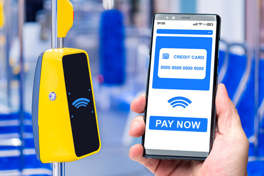 NFC payment via mobile phone. Smartphone with credit card on screen. Terminal for accepting payments on bus. Payment for travel by contactless method. Banking application on phone. NFC technology