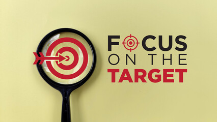 Focus on the target typography with magnifying glass on yellow background. motivational quote....