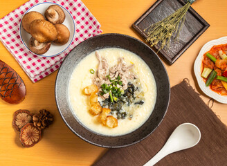 Century Egg and Lean Meat Porridge with mushroom,chopsticks and spoon served in bowl isolated on wooden table top view of taiwan food