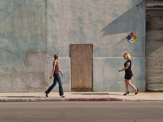 Two Caucasian Blond Women Walking Towards Each Other