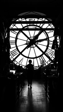 Paris, France: Orsay Museum Clock with silhouette of person 