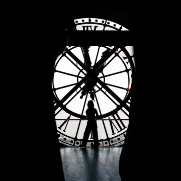 Paris, France: Orsay Museum Clock with silhouette of tourists taking picture