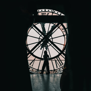 Paris, France: Orsay Museum Clock with silhouette of tourists taking picture