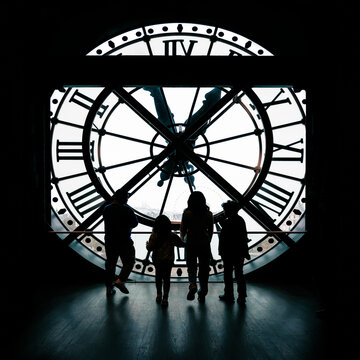 Paris, France: Orsay Museum Clock with silhouette of tourists taking picture