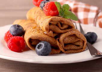Chocolate crepes with sweet filling,