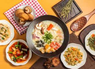 Cantonese porridge,Jellyfish skin,kelp silk,mix pickle,scallop lips and mushroom with chopsticks and spoon served in bowl isolated on wooden table top view of taiwan food