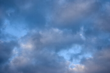 Cumulus clouds, white and gray filled the sky, only in places the heavenly blue is visible, a beautiful landscape of the sky