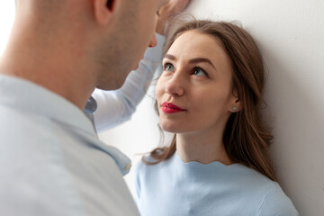 young serious couple in love looking into eyes closely, woman in eye contact with man in relationship