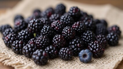 Fresh ripe blackberries on linen cloth rustic setting