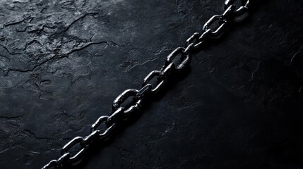 A single broken chain on a dark background, representing the issue of human trafficking and modern slavery, minimalist style