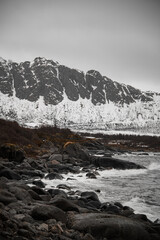Beautiful landscape of seaside mountains covered with snow, the rocky