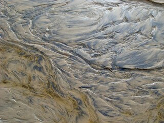Abstract sand patterns with water reflections in Thurso, Scotland