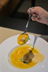 Rich Pumpkin Soup Spoonful with Crouton Garnish