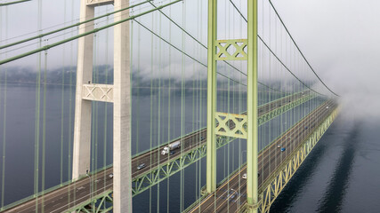 Fototapeta premium Close up of the Tacoma Narrows Bridge during an early morning with fog rolling in.