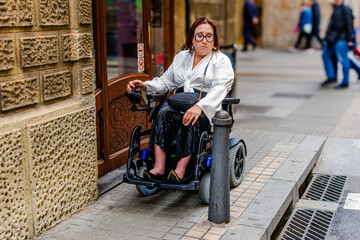 Wheelchair User Confronting Sidewalk Bollard Obstacle