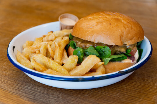 Burger and chips on a restaurant table, no visible people