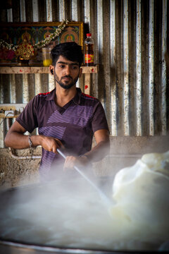 Indian young boy preparing for sweet