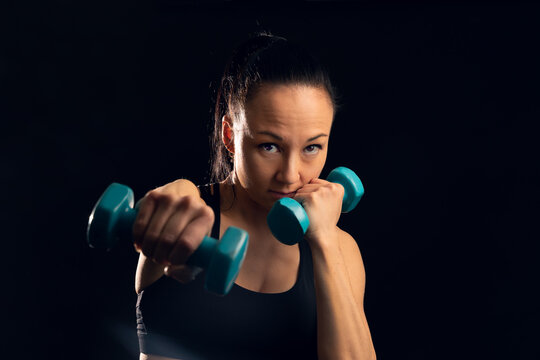 Woman using blue dumbbells
