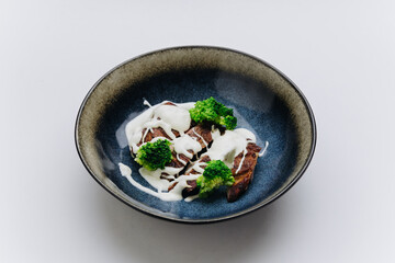 Grilled chicken with creamy sauce and broccoli, delicious combination of flavor and health
