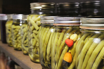Pantry shelf of homemade canned beans; colorful display of old-fashioned food preserves