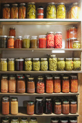 Pantry of homemade canned vegetables and fruit;  colorful display of old-fashioned food preserves