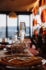 Elegant glass of champagne on festive table setting, ready for refined celebration or dining event