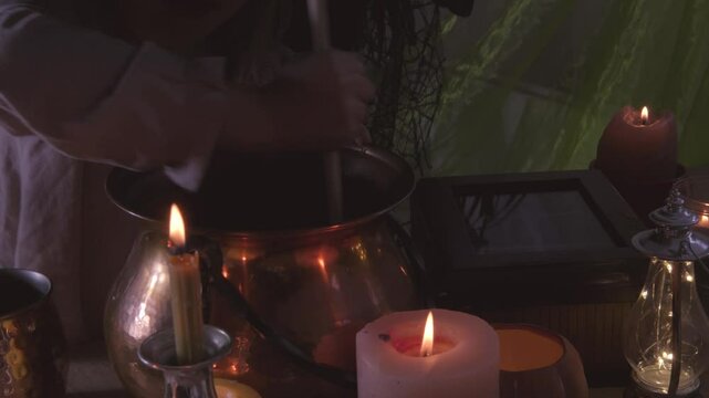 young witch stirs mystical potion in copper cauldron, adding charm to Halloween party atmosphere, magical potion, whimsical charm
