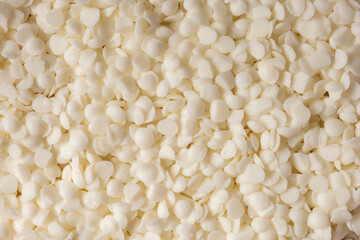 Granulated soy wax. Ingredients for making scented candles.