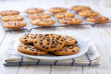 Chocolate chip cookies on white wooden table, selective focus.