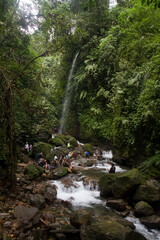 Obraz premium Bogor, Indonesian -January 07, 2024: There are many people at Umbrella waterfall,destination for the people of Bogor City, West Java