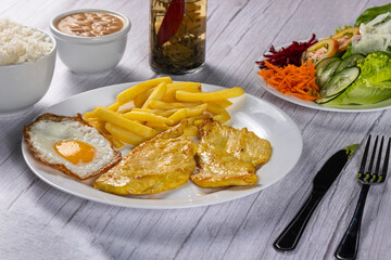 grilled chicken with eggs, fries and vegetables