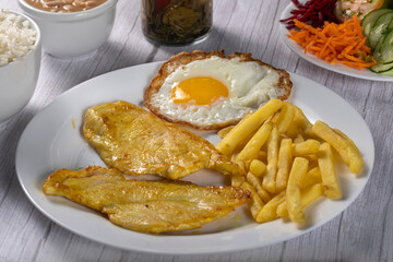 grilled chicken with eggs, fries and vegetables