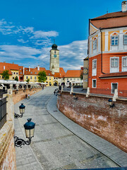 View of the city of Sibiu, Romania, with roofs with eye-shaped windows, cobblestone street on a...