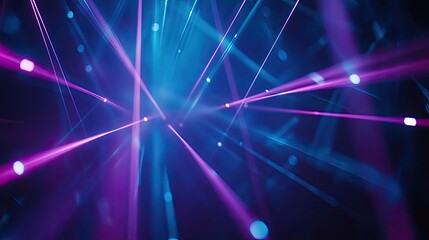 Blue and violet beams of bright laser light shining on black background 