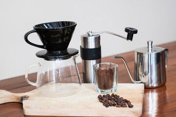 V60 coffee method of making coffee with Complete V60 set tools on the wooden table, making homemade...