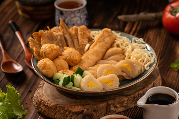 Pempek is a savoury Indonesian fishcake delicacy, made of fish and tapioca from Palembang. Pempek is served with sweet and sour sauce.