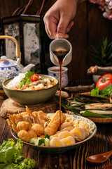 Pempek is a savoury Indonesian fishcake delicacy, made of fish and tapioca from Palembang. Pempek is served with sweet and sour sauce.