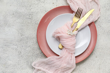 Beautiful table setting with golden cutlery and lilac flowers on white background
