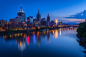 Obraz premium Nashville skyline illuminated at blue hour, with fireworks over the riverfront, capturing the vibrant and festive energy of the city