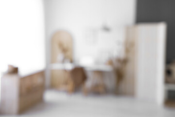 Modern workplace with laptop, home decor and folding screen, blurred view