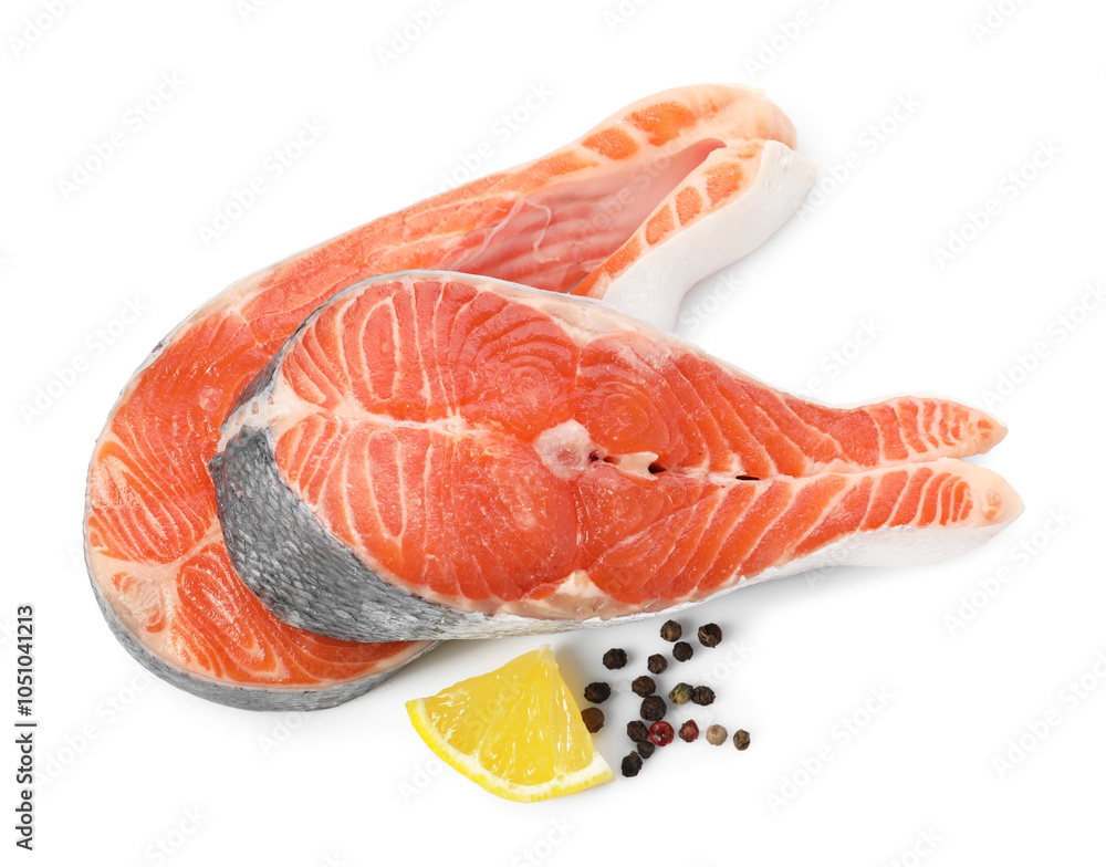 Wall mural two fresh salmon steaks, lemon and peppercorns isolated on white, above view