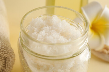 Glass jar of natural body scrub on color background, closeup