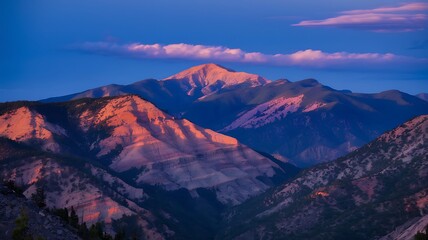 Fototapeta premium Mountain Range Bathed in Pink and Blue Light at Sunset