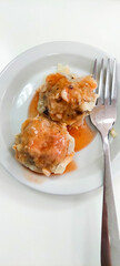 Dimsum with chili sauce on a plate with fork