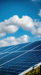 A solar panel is on a roof with a blue sky in the background. The sky is partly cloudy, but the sun is shining through the clouds. The solar panel is a symbol of renewable energy
