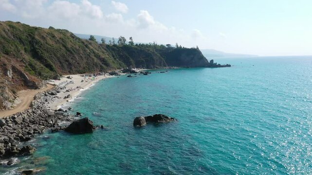 Aerial view of sea and rocky beach in Marinella Di Zambrone on a sunny summer day in Calabria, Italy