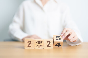 2024 year change to 2025 year block with dartboard icon. Goal, Target, Resolution, strategy, plan,...